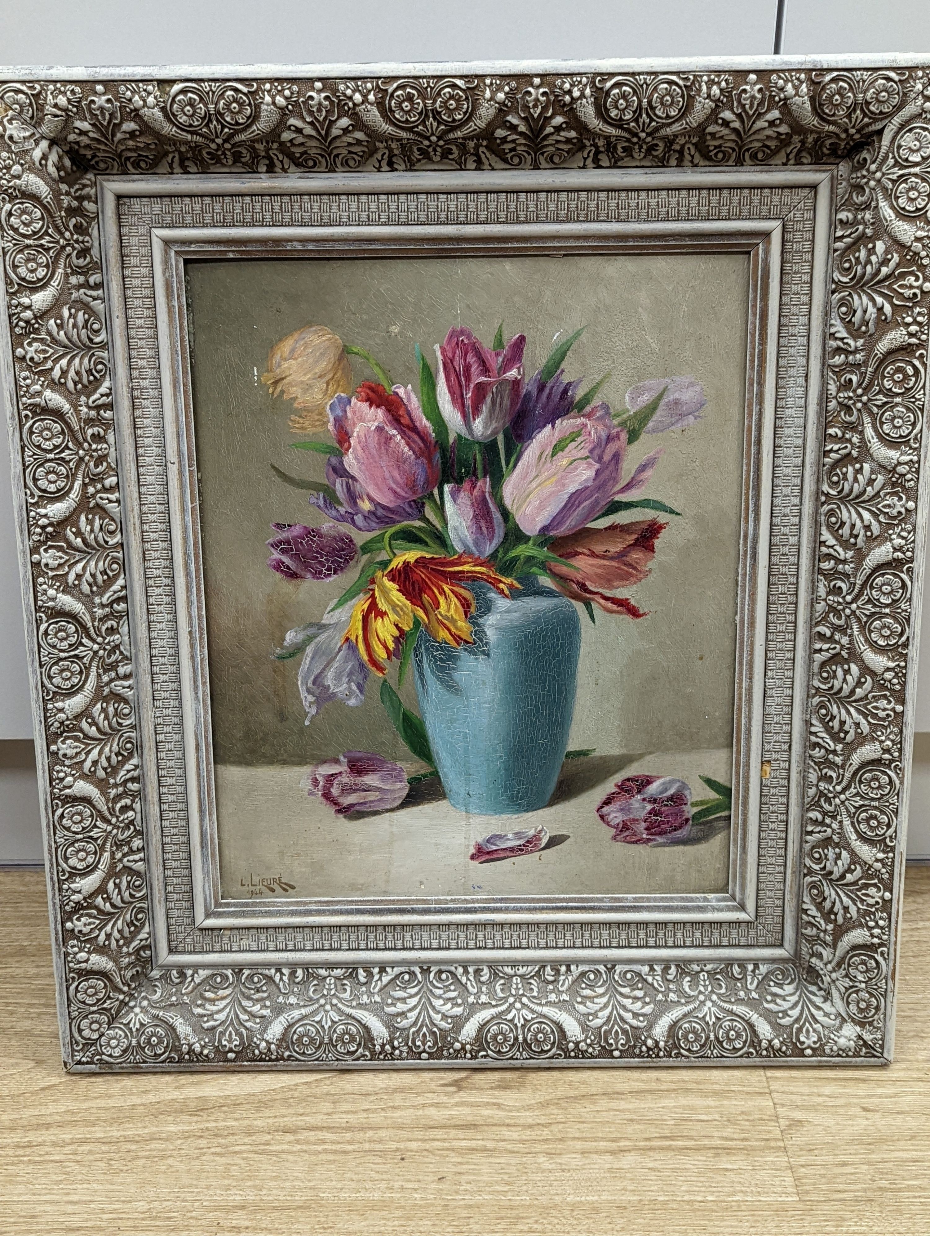 L. Lievré, oil on wooden panel, Still life of tulips in a blue vase, signed and dated 1944, 40 x 32cm